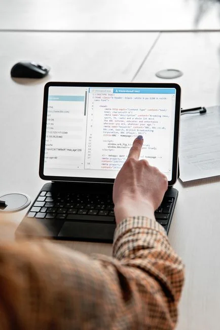 A modern computer screen displaying web design work, showcasing creative visuals in a workspace.